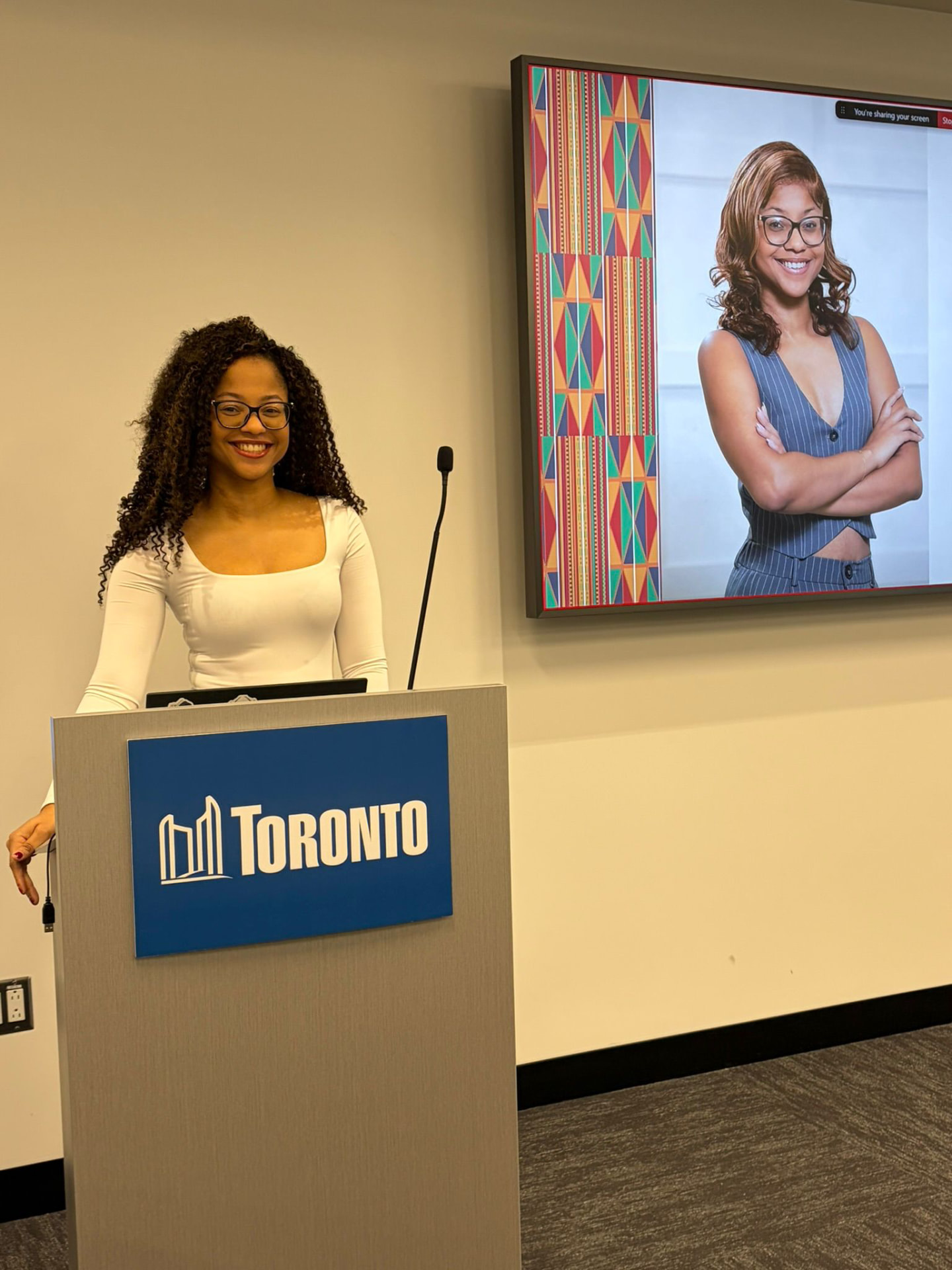 Kellina Powell speaking at a City of Toronto event podium